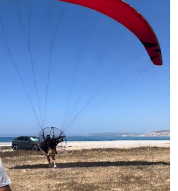 Close Call for Paraglider During Takeoff (VIDEO)